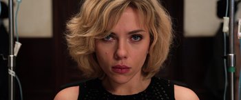 Movie still from “Lucy” (2014), directed by Luc Besson – A person with short blonde hair; Close Up shot, Low angle