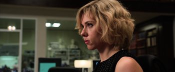 Movie still from “Lucy” (2014), directed by Luc Besson – A person wearing a black shirt; Close Up shot, Over the shoulder angle