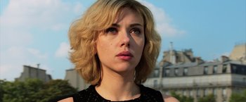 Movie still from “Lucy” (2014), directed by Luc Besson – A person wearing a black shirt; Close Up shot, Low angle