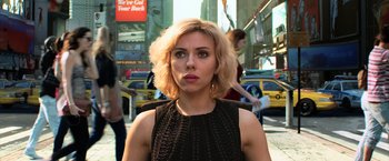 Movie still from “Lucy” (2014), directed by Luc Besson – A person wearing a black dress; Close Up shot, Low angle