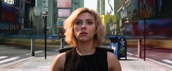 Movie still from “Lucy” (2014), directed by Luc Besson – A person wearing a black dress; Close Up shot, Low angle