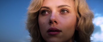 Movie still from “Lucy” (2014), directed by Luc Besson – A woman's eyes and lips; Close Up shot, Low angle