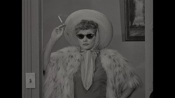 Movie still from “Lucy and Desi” (2022), directed by Amy Poehler – An old photo of a woman wearing a hat and sunglasses; Medium shot, Low angle