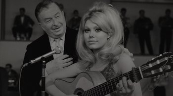 Movie still from “Lucy and Desi” (2022), directed by Amy Poehler – An older man and a young woman playing a guitar; Close Up shot, Low angle