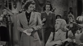 Movie still from “Lucy and Desi” (2022), directed by Amy Poehler – A group of women standing next to each other in a room; Medium shot, Over the shoulder angle