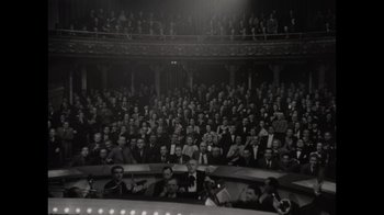 Movie still from “Lucy and Desi” (2022), directed by Amy Poehler – An old photo of a crowd of people sitting in a theater; Extreme Wide shot, High angle