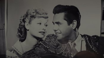 Movie still from “Lucy and Desi” (2022), directed by Amy Poehler – A black and white photo of a man and a woman; Close Up shot, Overhead angle