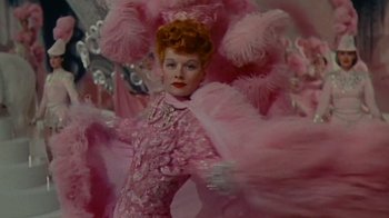 Movie still from “Lucy and Desi” (2022), directed by Amy Poehler – A person wearing a costume; Medium shot, Low angle