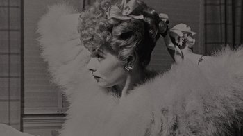 Movie still from “Lucy and Desi” (2022), directed by Amy Poehler – An old photo of a woman in a fur coat with flowers in her hair; Close Up shot, Low angle