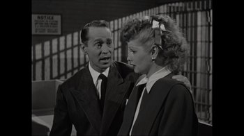 Movie still from “Lucy and Desi” (2022), directed by Amy Poehler – A man and a woman standing next to each other; Medium shot, Over the shoulder angle