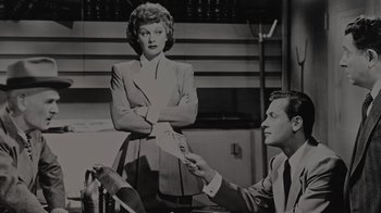 Movie still from “Lucy and Desi” (2022), directed by Amy Poehler – An old black and white photo of a man and a woman; Medium shot, Low angle