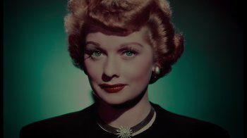 Movie still from “Lucy and Desi” (2022), directed by Amy Poehler – A person wearing a necklace; Close Up shot, Overhead angle