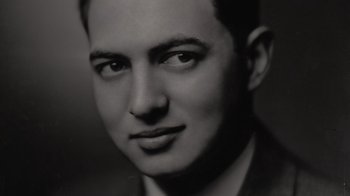 Movie still from “Lucy and Desi” (2022), directed by Amy Poehler – A black and white photo of a man in a suit; Close Up shot, Low angle