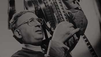 Movie still from “Lucy and Desi” (2022), directed by Amy Poehler – An old photo of a man holding a film roll; Close Up shot, Low angle