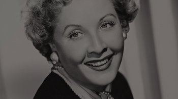 Movie still from “Lucy and Desi” (2022), directed by Amy Poehler – An old photo of an older woman smiling for the camera; Close Up shot, High angle