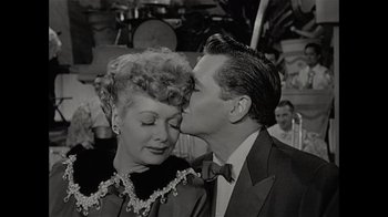 Movie still from “Lucy and Desi” (2022), directed by Amy Poehler – An old black and white photo of a man and a woman kissing; Close Up shot, Low angle