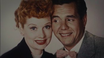 Movie still from “Lucy and Desi” (2022), directed by Amy Poehler – An old photo of a man and a woman smiling; Extreme Close Up shot, Low angle