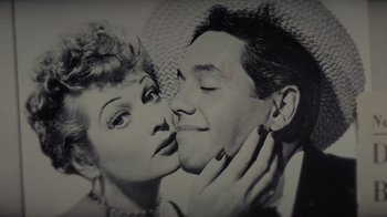 Movie still from “Lucy and Desi” (2022), directed by Amy Poehler – A black and white photo of a man and a woman kissing; Close Up shot, Overhead angle