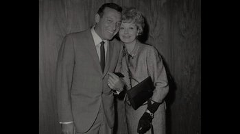 Movie still from “Lucy and Desi” (2022), directed by Amy Poehler – An older man standing next to an older woman; Medium shot, High angle