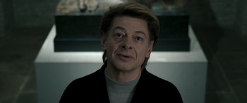 Movie still from “Luther: The Fallen Sun” (2023), directed by Jamie Payne – A person wearing a black jacket; Close Up shot, Over the shoulder angle