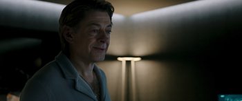 Movie still from “Luther: The Fallen Sun” (2023), directed by Jamie Payne – A person wearing a white shirt; Close Up shot, Over the shoulder angle