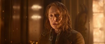 Movie still from “Luther: The Fallen Sun” (2023), directed by Jamie Payne – A person with long hair; Close Up shot, Over the shoulder angle