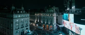 Movie still from “Luther: The Fallen Sun” (2023), directed by Jamie Payne – An aerial view of a city at night; Extreme Wide shot, High angle