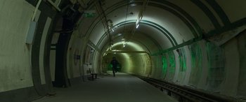 Movie still from “Luther: The Fallen Sun” (2023), directed by Jamie Payne – A man is walking in a subway tunnel; Extreme Wide shot, High angle