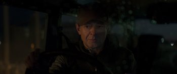 Movie still from “Luther: The Fallen Sun” (2023), directed by Jamie Payne – A person wearing a hat; Close Up shot, Over the shoulder angle