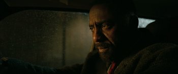 Movie still from “Luther: The Fallen Sun” (2023), directed by Jamie Payne – A person in a car window; Close Up shot, Over the shoulder angle