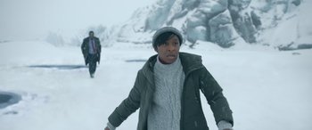 Movie still from “Luther: The Fallen Sun” (2023), directed by Jamie Payne – Two people walking in the snow on a snowy day; Medium shot, Low angle