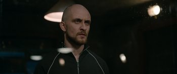 Movie still from “Luther: The Fallen Sun” (2023), directed by Jamie Payne – A man with a bald head is looking into the distance; Close Up shot, Low angle