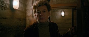 Movie still from “Luther: The Fallen Sun” (2023), directed by Jamie Payne – A person wearing a jacket; Close Up shot, Over the shoulder angle