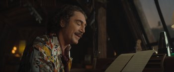 Movie still from “Lyle, Lyle, Crocodile” (2022), directed by Will Speck – A man with long hair and a mustache sitting at a piano; Close Up shot, Low angle