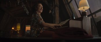 Movie still from “Lyle, Lyle, Crocodile” (2022), directed by Will Speck – A man is playing the piano in a room; Medium shot, Low angle