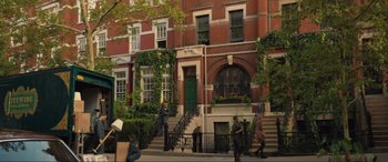 Movie still from “Lyle, Lyle, Crocodile” (2022), directed by Will Speck – People are walking down the steps in front of a brick building; Extreme Wide shot, Low angle