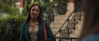 A woman standing in front of a set of stairs