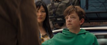 Movie still from “Lyle, Lyle, Crocodile” (2022), directed by Will Speck – A young man and a young woman sitting next to each other; Close Up shot, Over the shoulder angle