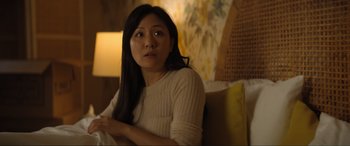 Movie still from “Lyle, Lyle, Crocodile” (2022), directed by Will Speck – A woman sitting on a couch in a living room; Close Up shot, Over the shoulder angle