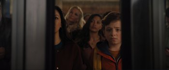 Movie still from “Lyle, Lyle, Crocodile” (2022), directed by Will Speck – A group of people standing in a room; Medium shot, Over the shoulder angle