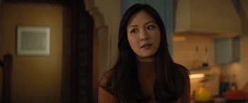 Movie still from “Lyle, Lyle, Crocodile” (2022), directed by Will Speck – A woman with long black hair wearing an orange sweater; Close Up shot, Over the shoulder angle