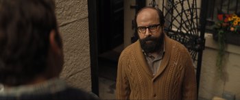 Movie still from “Lyle, Lyle, Crocodile” (2022), directed by Will Speck – A man with a goatee and a beard wearing a sweater; Close Up shot, Over the shoulder angle