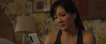 Movie still from “Lyle, Lyle, Crocodile” (2022), directed by Will Speck – A woman looking at her cell phone in a room; Close Up shot, Over the shoulder angle