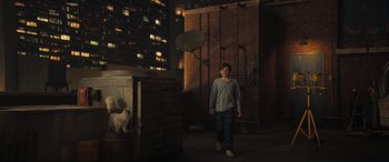 Movie still from “Lyle, Lyle, Crocodile” (2022), directed by Will Speck – A boy and a white cat in a dark room; Wide shot, High angle