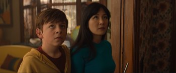 Movie still from “Lyle, Lyle, Crocodile” (2022), directed by Will Speck – A woman and a boy are standing next to each other; Close Up shot, Low angle