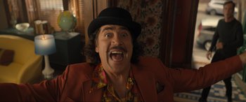 Movie still from “Lyle, Lyle, Crocodile” (2022), directed by Will Speck – A person wearing a hat and a jacket; Medium shot, Low angle