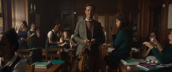 Movie still from “Lyle, Lyle, Crocodile” (2022), directed by Will Speck – A man in a suit and tie standing next to a woman in a green dress; Medium shot, Low angle