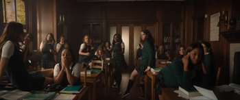 Movie still from “Lyle, Lyle, Crocodile” (2022), directed by Will Speck – A group of people in a room with books and papers; Wide shot, High angle