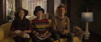 Movie still from “Lyle, Lyle, Crocodile” (2022), directed by Will Speck – A man and a boy sitting next to each other on a couch; Medium shot, Over the shoulder angle