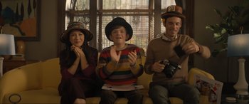 Movie still from “Lyle, Lyle, Crocodile” (2022), directed by Will Speck – A group of people sitting next to each other on a couch; Medium shot, High angle